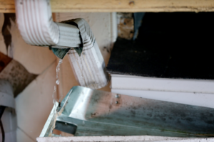 a closeup of water flowing from a gutter