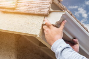 a person installing a gutter 